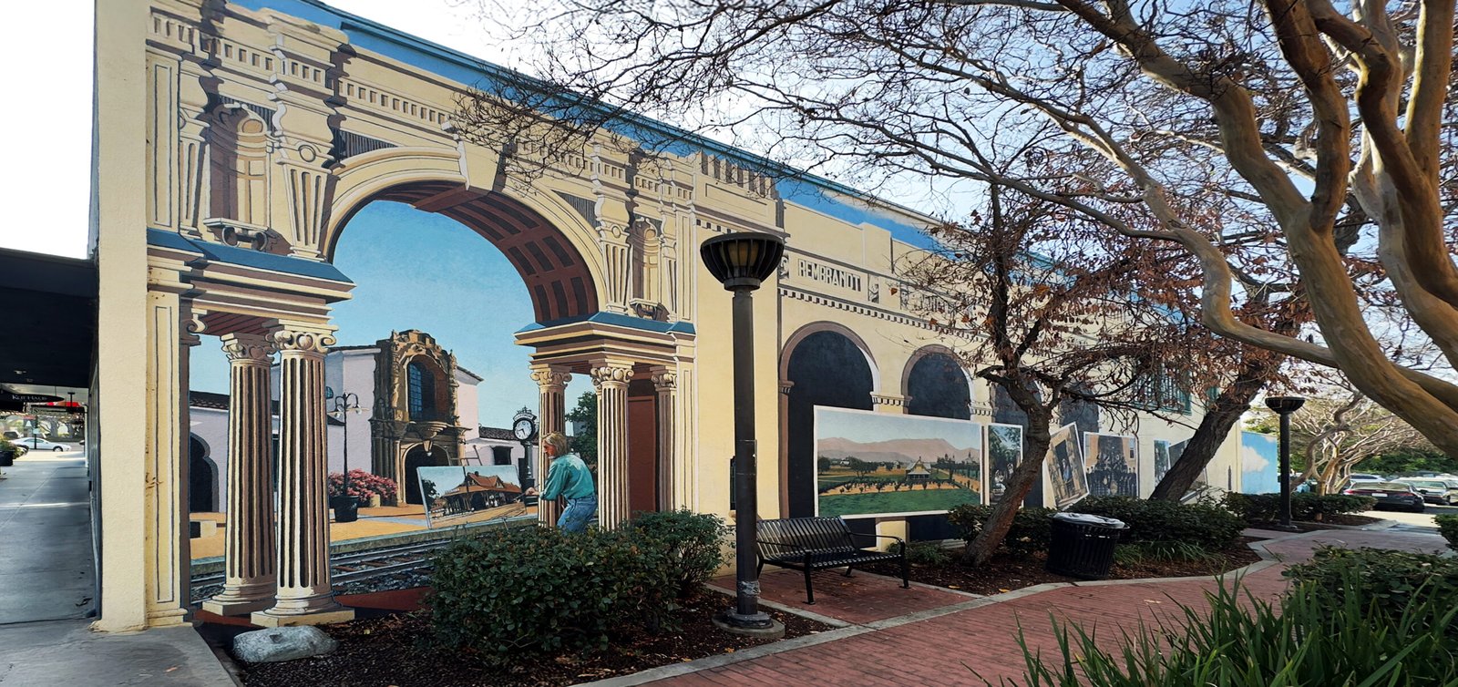 Mural by Art Mortimer depicting historic street scenes in Claremont Village.